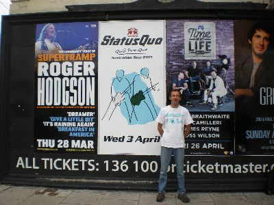 Lee posing with the Quo poster outside the Palais Theatre